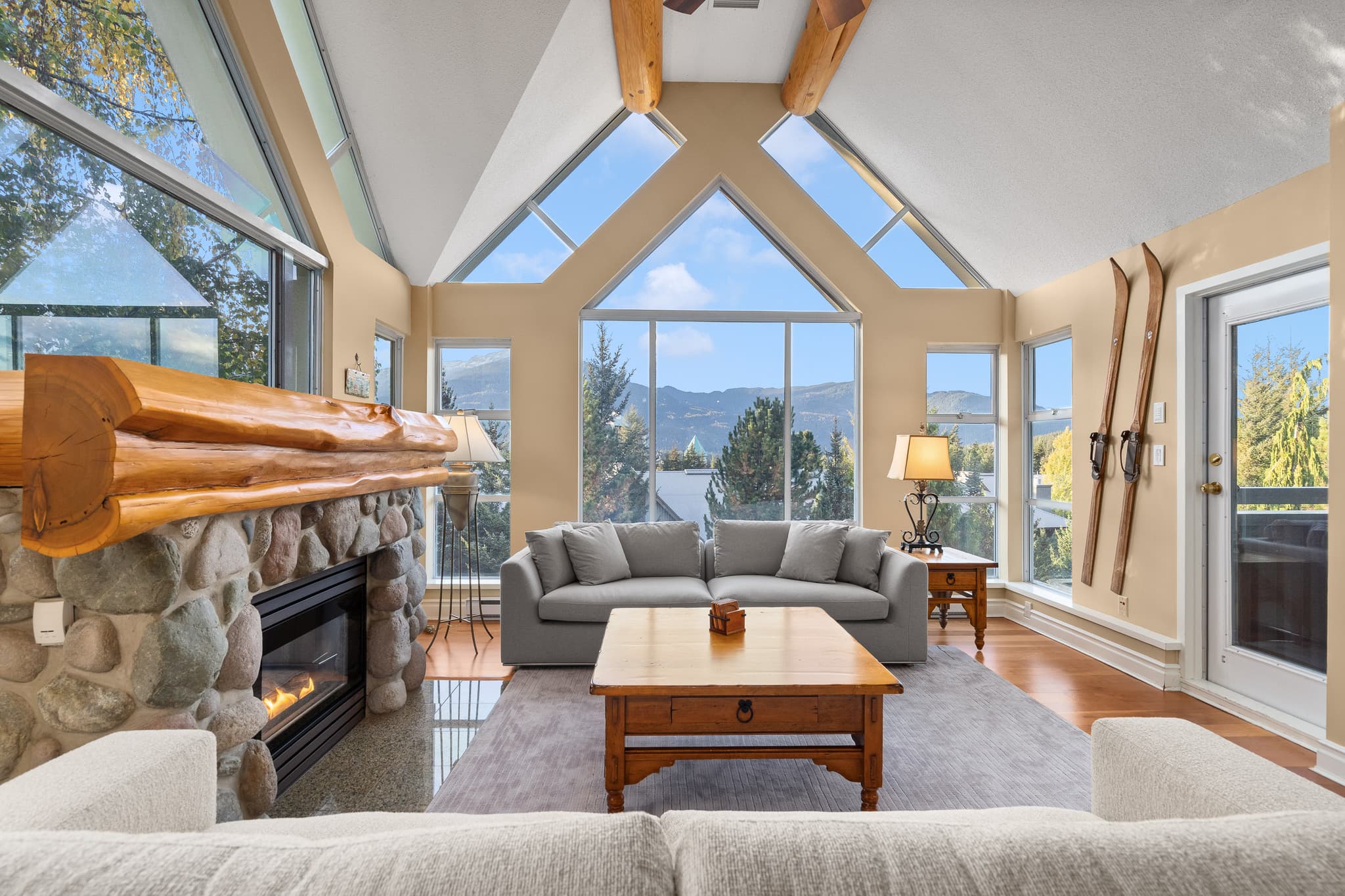 Woodrun Lodge penthouse living area with vaulted timber ceilings and mountain views
